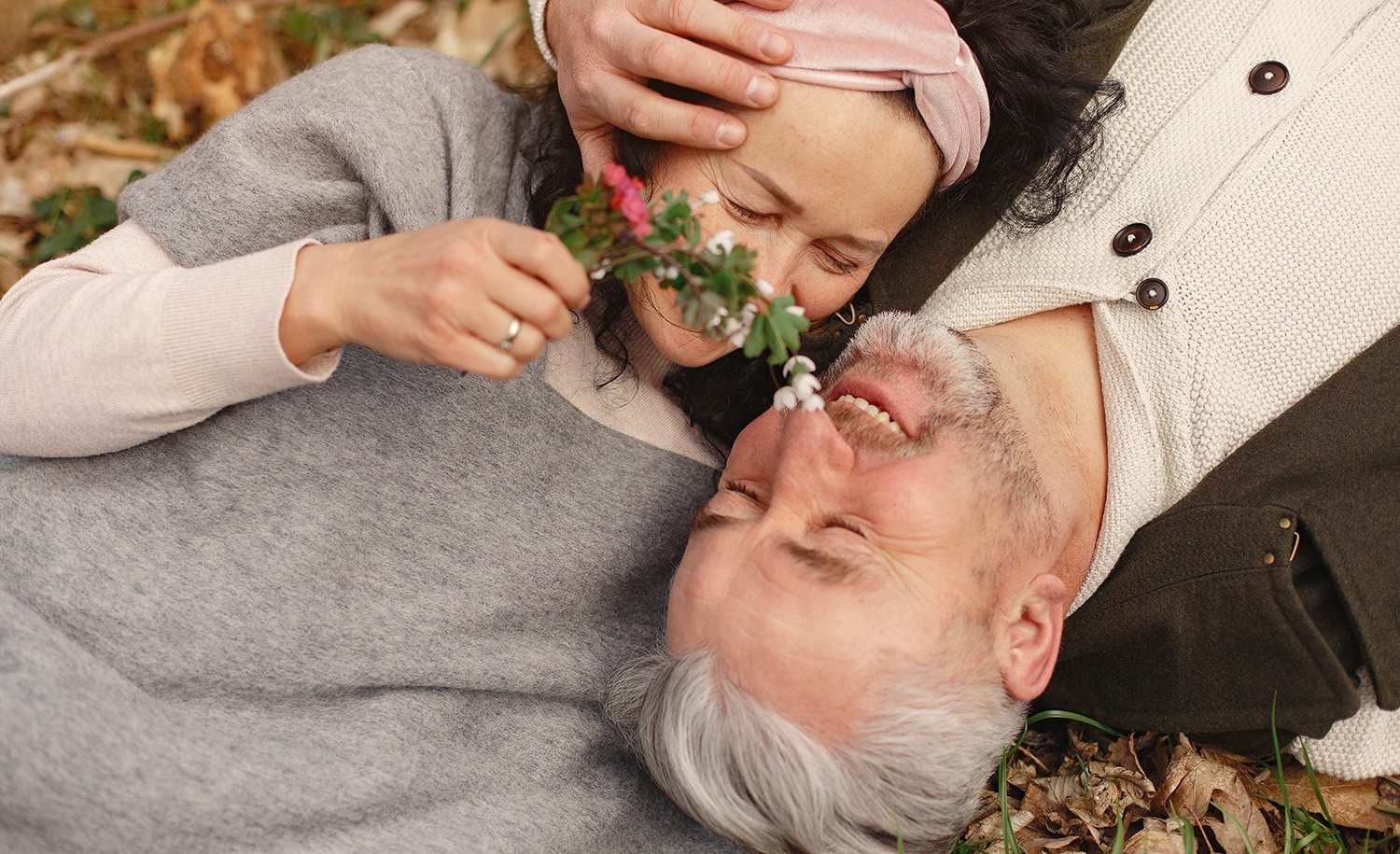 A highly sensitive couple lying in the grass