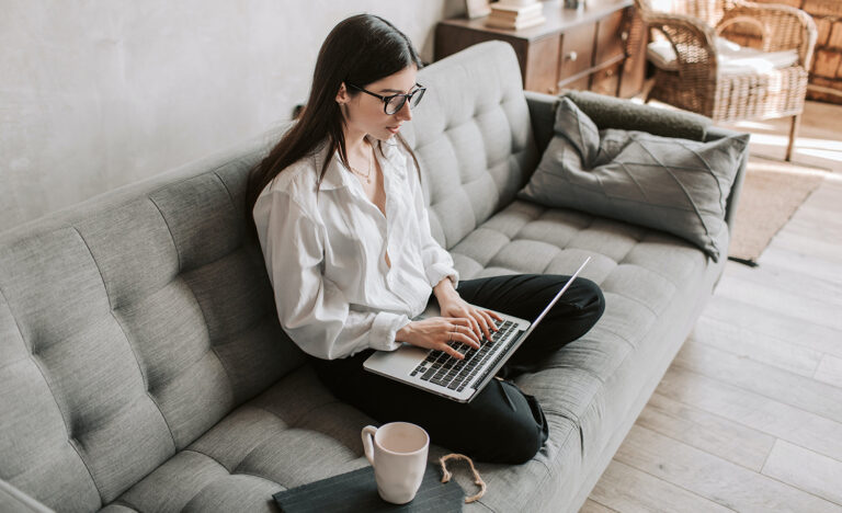 A freelancer works on her laptop