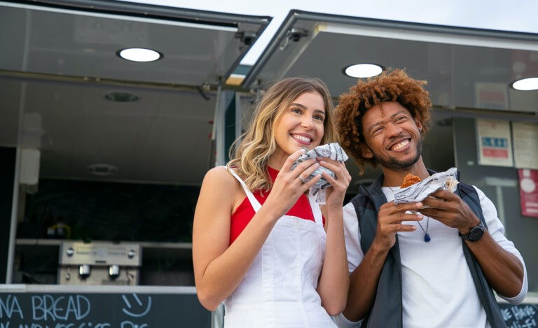 An introvert serves food to friends at a summer picnic