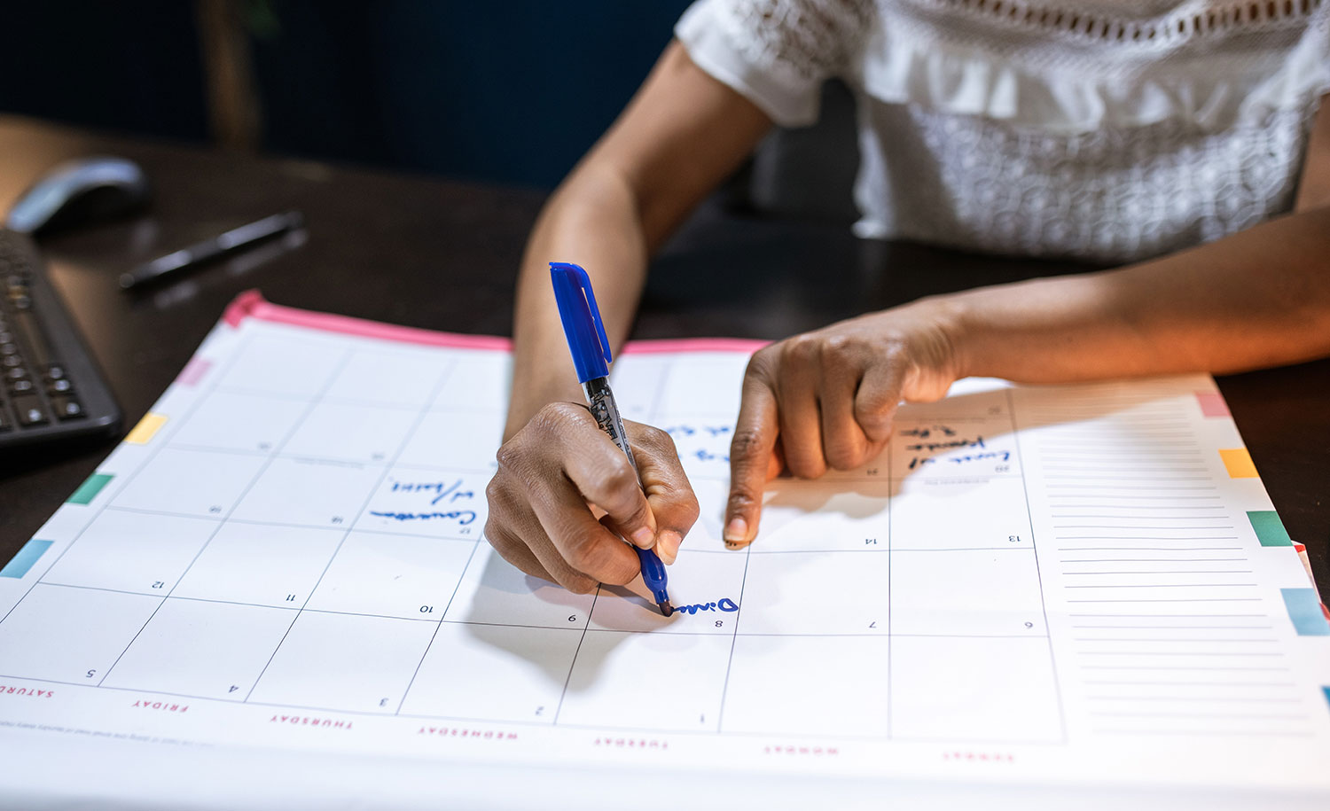 An introvert writes down plans on a large calendar