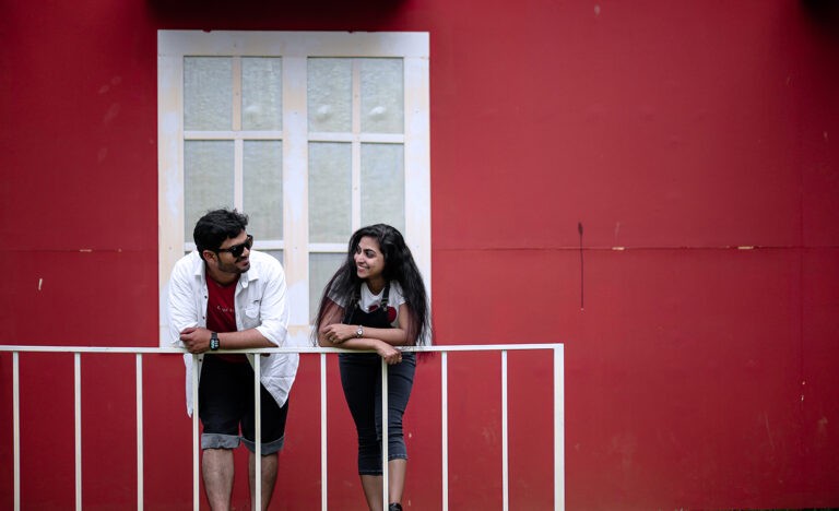 An introvert talks to her extroverted partner on a balcony