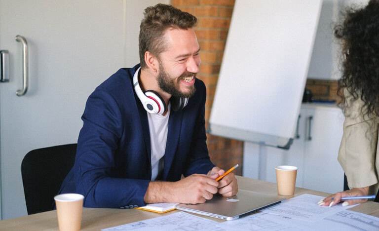 An introverted employee smiles at a coworker