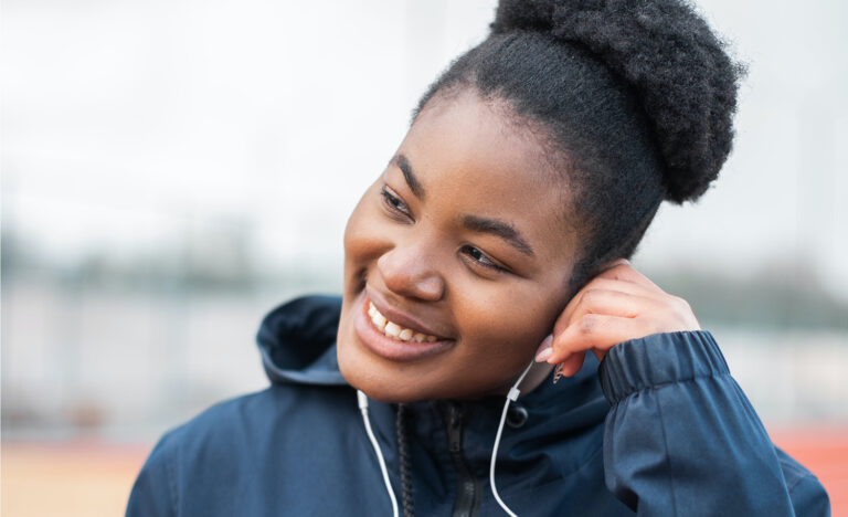 An introvert listening to music on her headphones