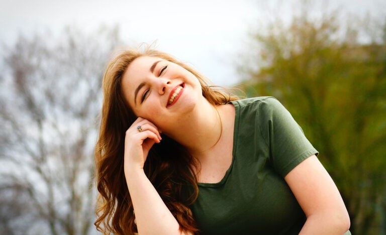 A smiling introvert takes care of her emotional health