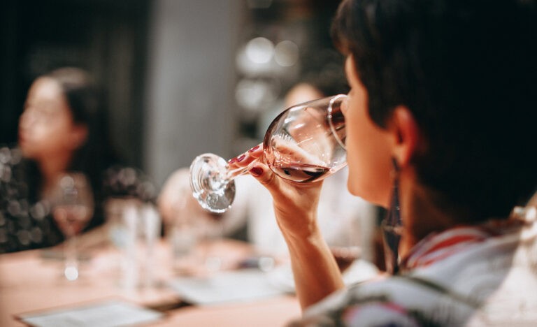 An introvert drinks a glass of wine