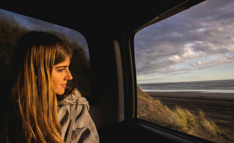 An introvert looks out the window, contemplative