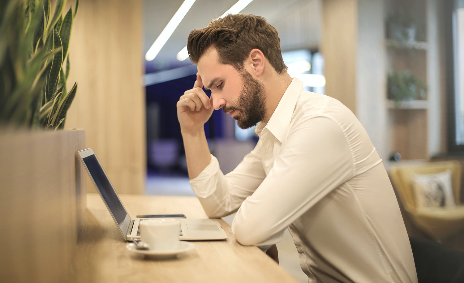 A highly sensitive man stares pensively at his computer