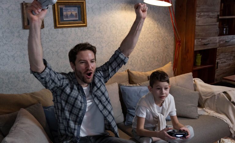 An introvert plays video games with a child