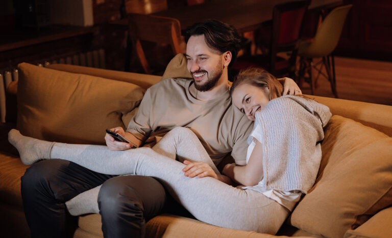 An introvert couple cuddling on the couch