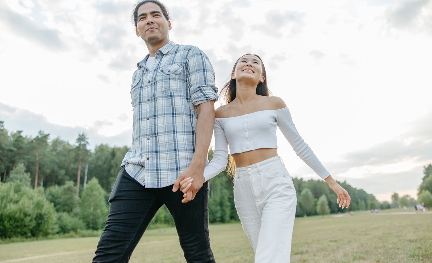 An introvert and extrovert couple walks down a path