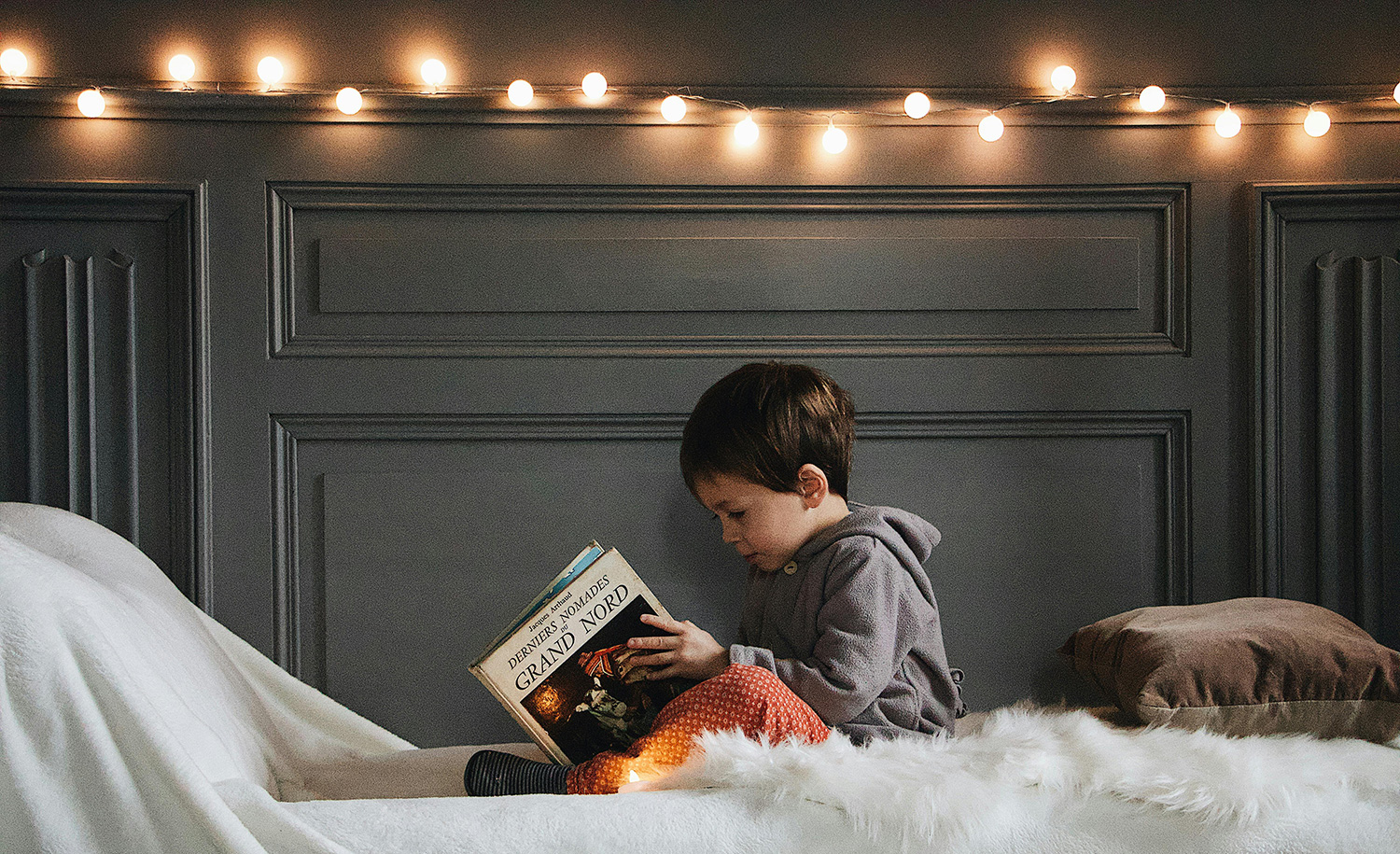 A boy reads on the bed