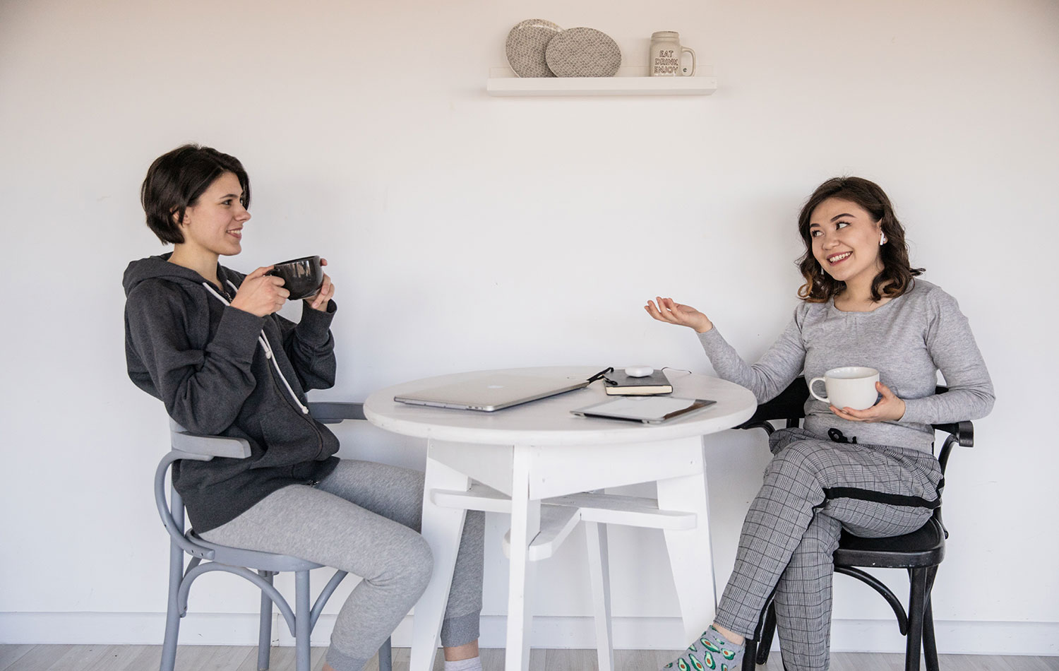 Two parents talk while having coffee