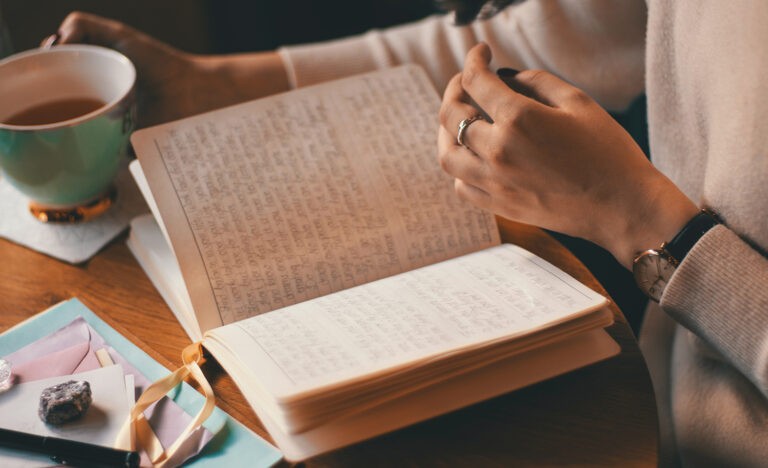 An introvert writes in a notebook