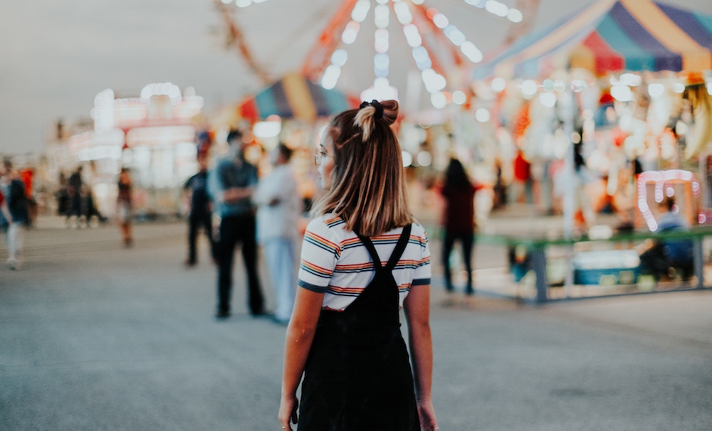 An ambivert walking alone at a social gathering.