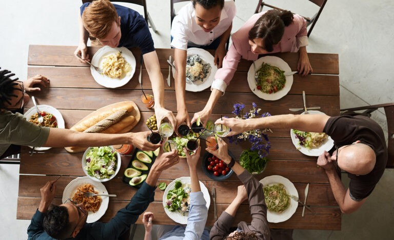 Guests make a toast at a dinner party