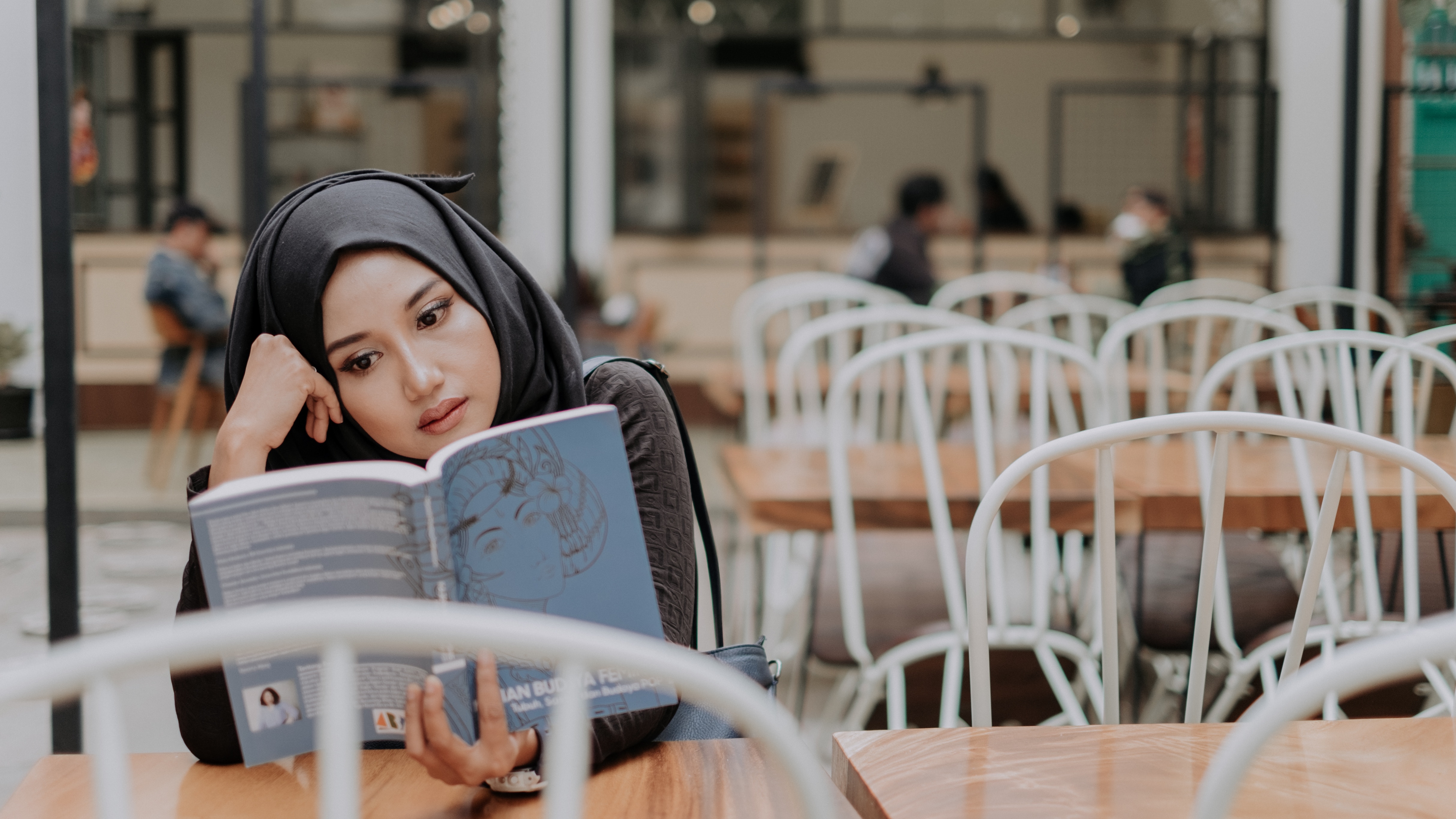 A woman reading about whether it's OK to be an introvert