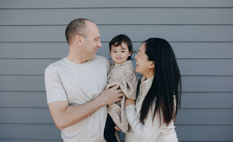 An introvert and an extrovert holding their child