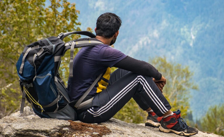 A man spends time alone looking at the mountains