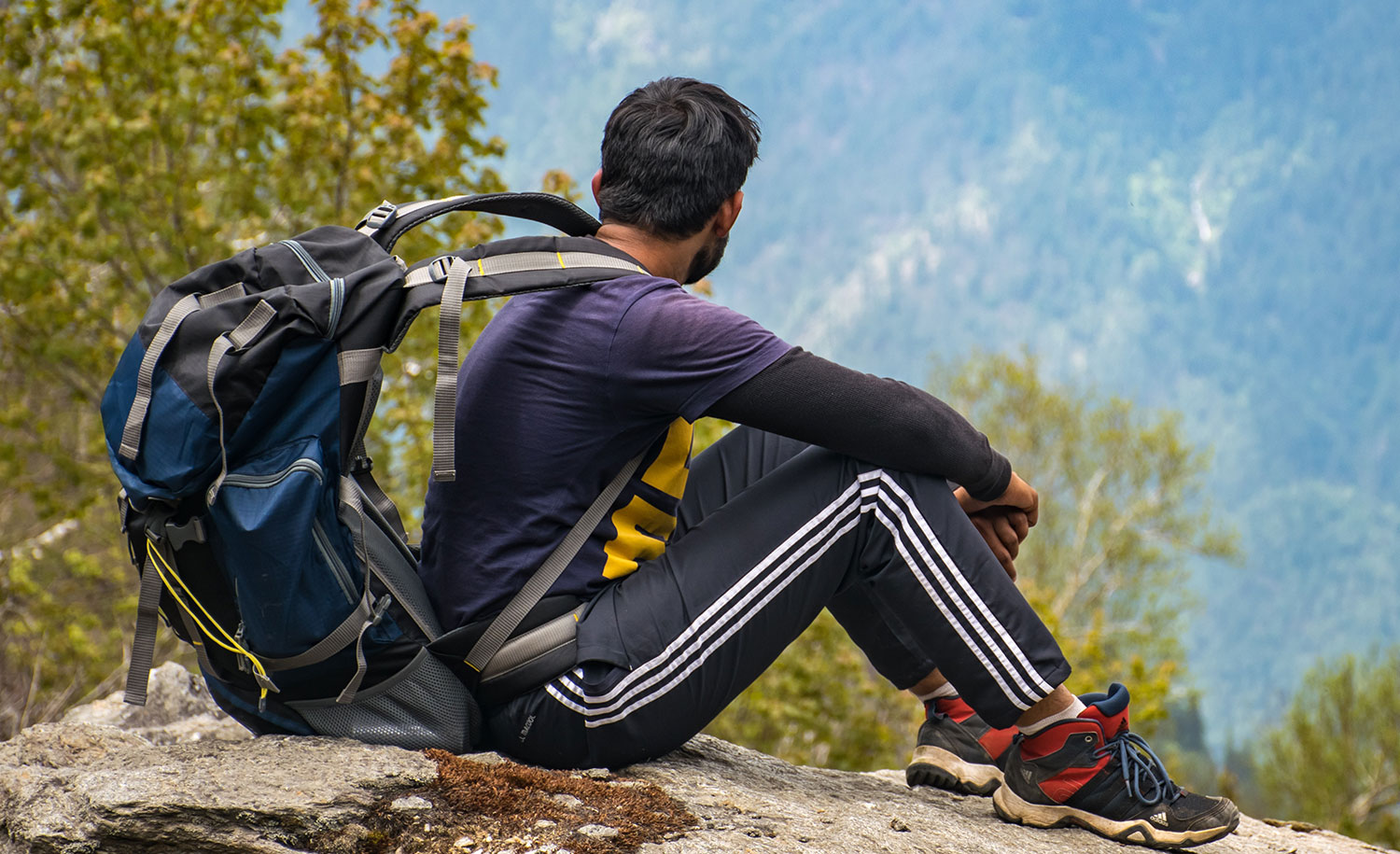 A man spends time alone looking at the mountains