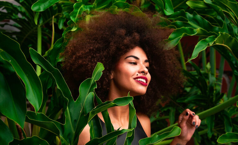 A highly sensitive introvert stands among greenery