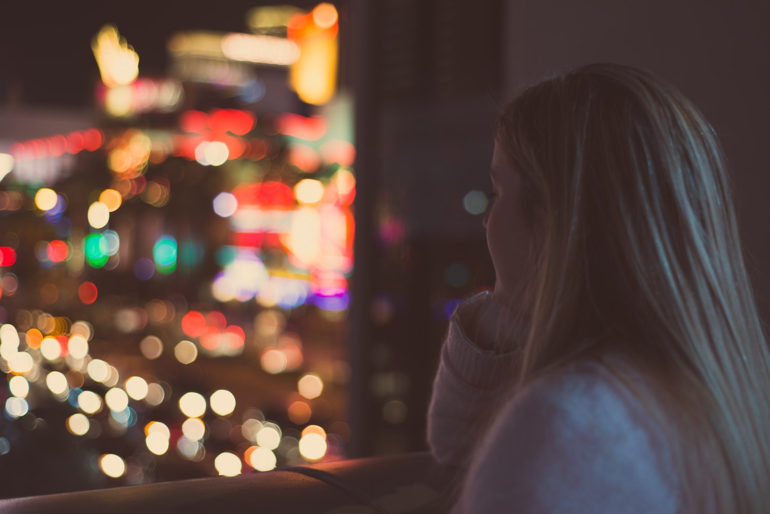 Woman at a window pondering what it feels like to be an introvert