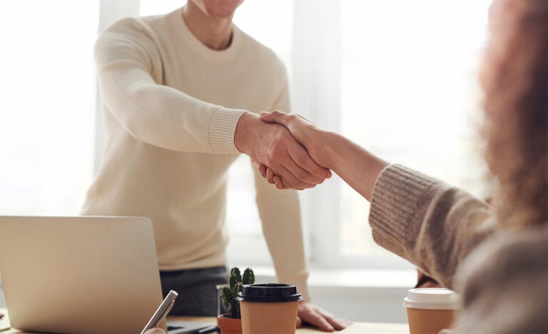 An employer shakes an introvert’s hand