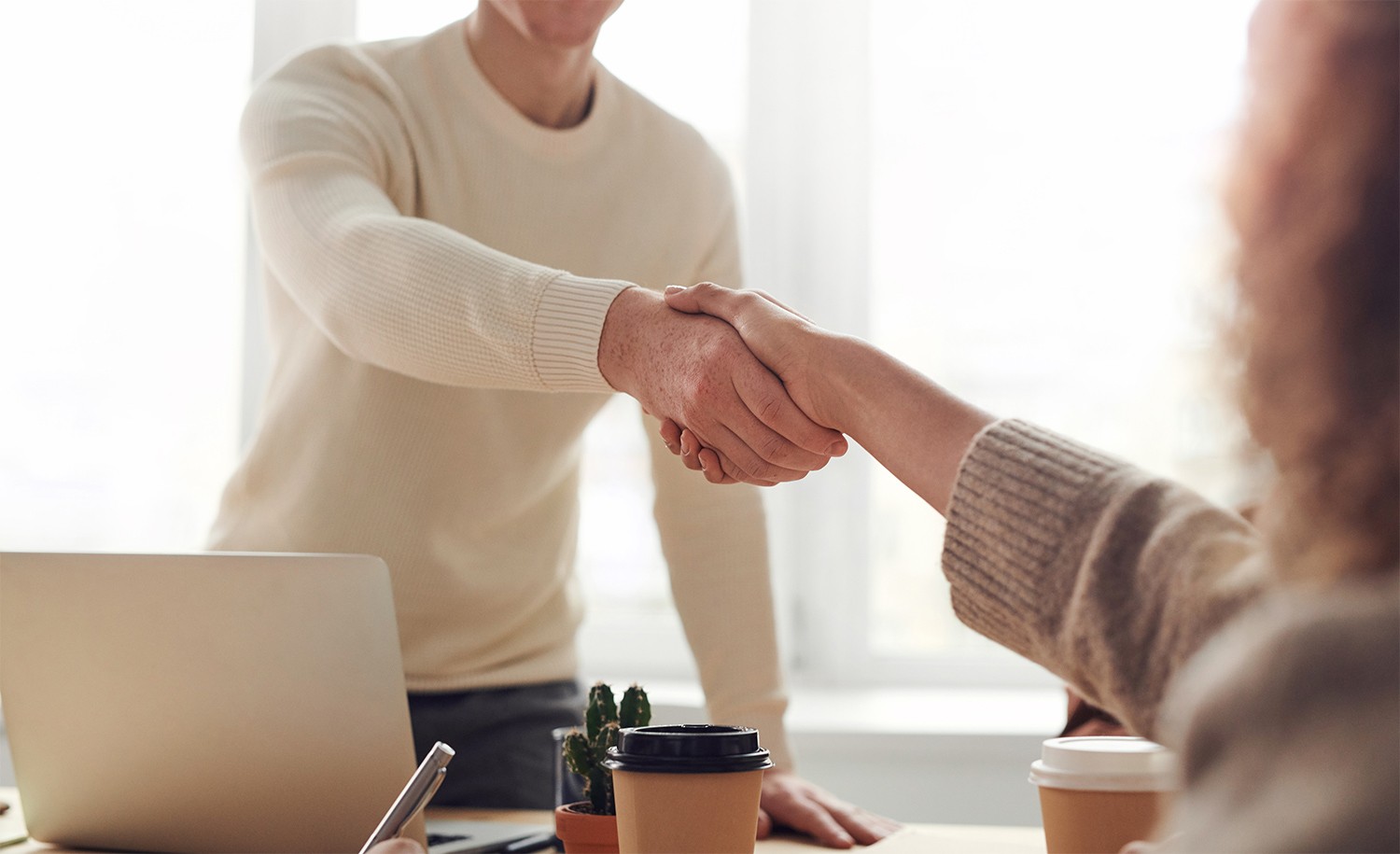 An employer shakes an introvert’s hand