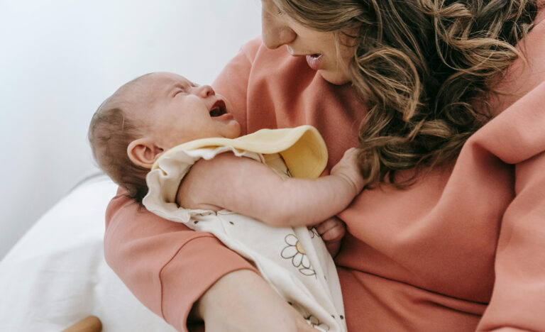 A highly sensitive, introverted mother holds her crying baby