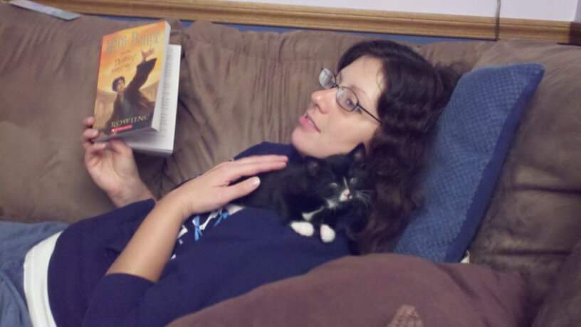 Me on my couch with my cat and my book