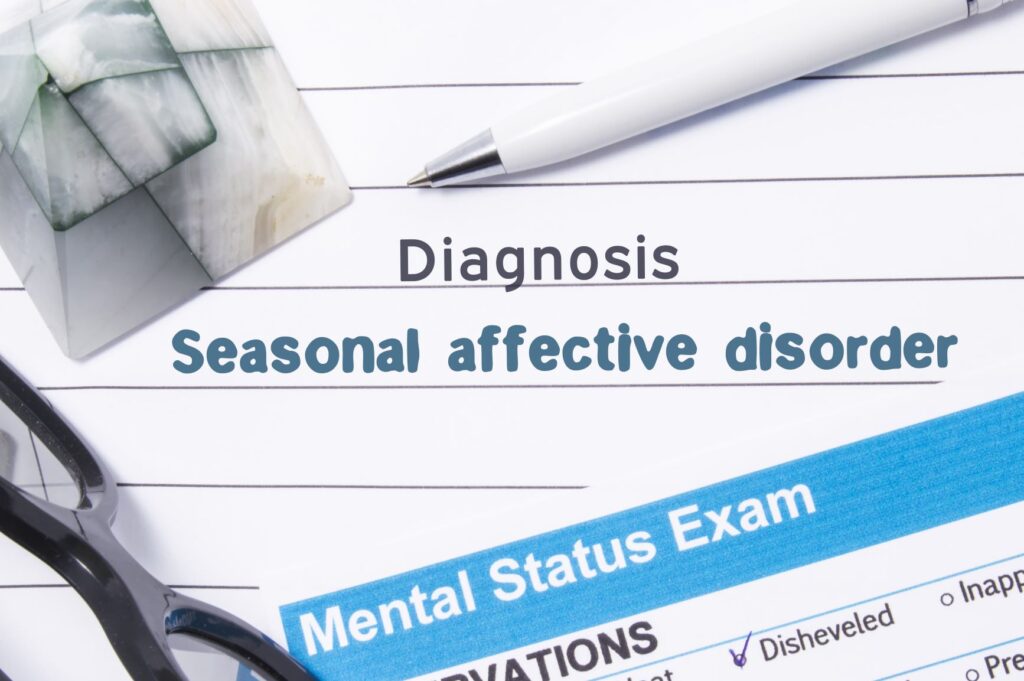 Notepad and pen with the words Diagnosis Seasonal Afftective Disorder in the center
